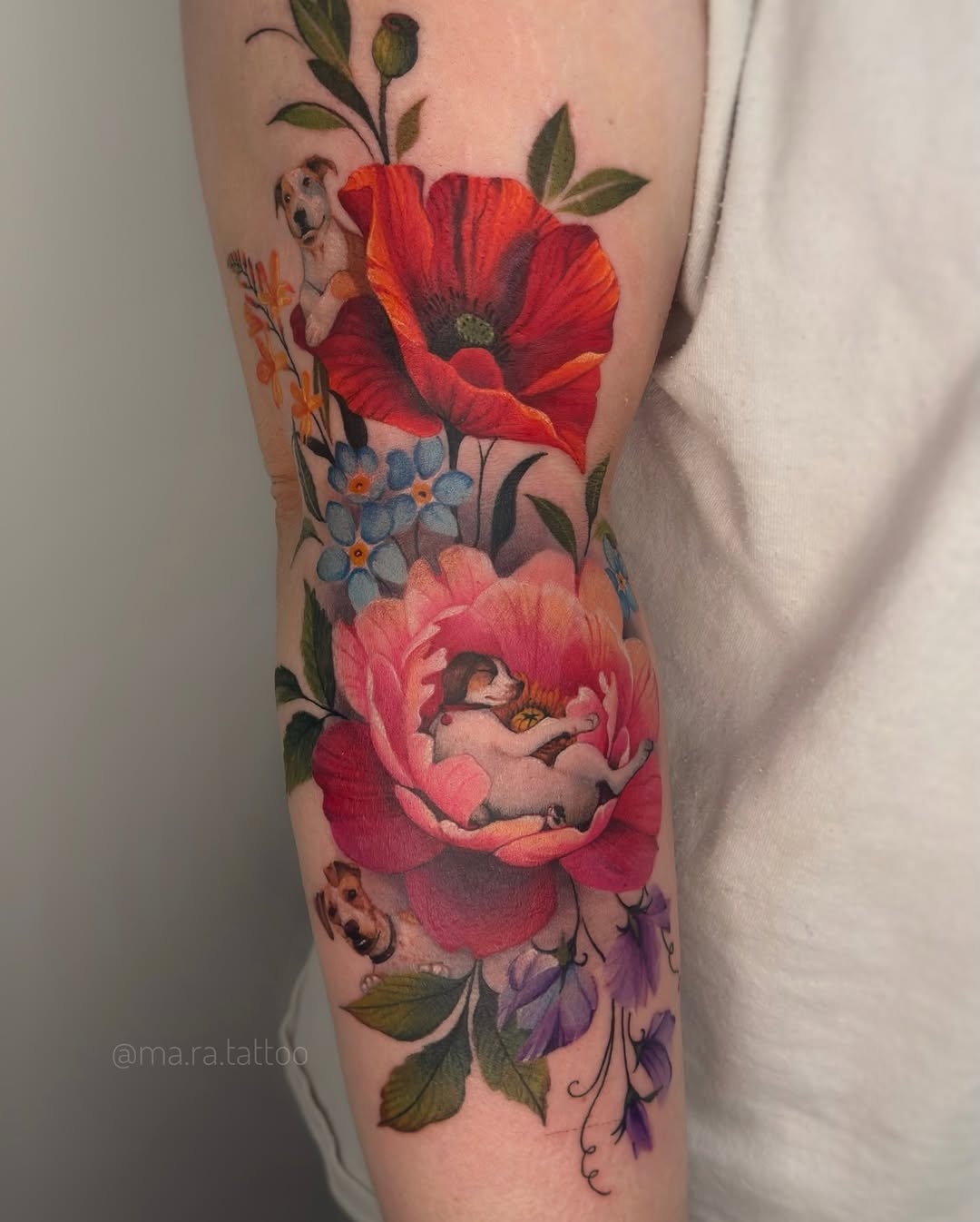 Vibrant floral sleeve with a tiny puppy nestled in petals