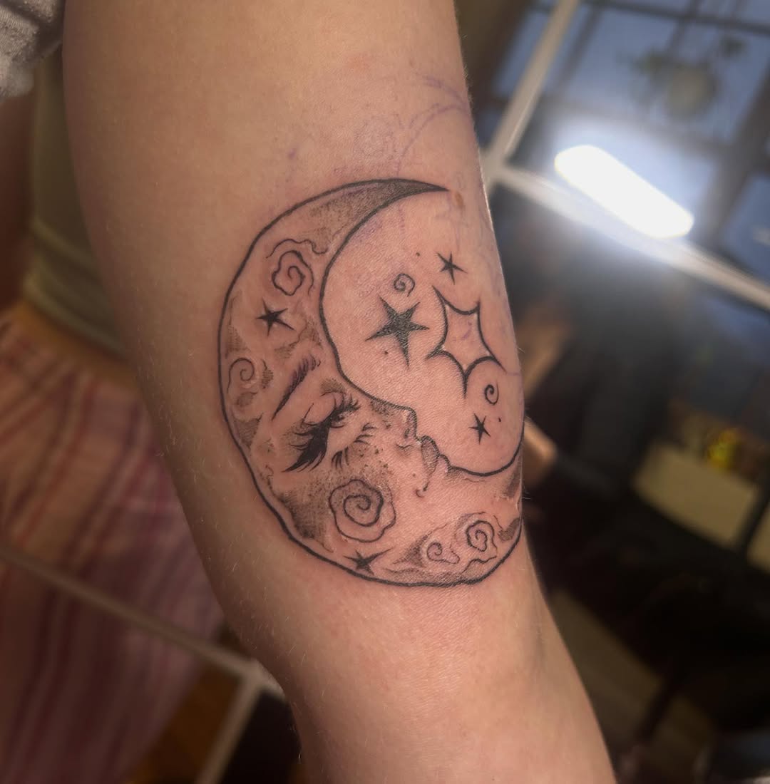 Whimsical crescent moon with sleeping face and stars