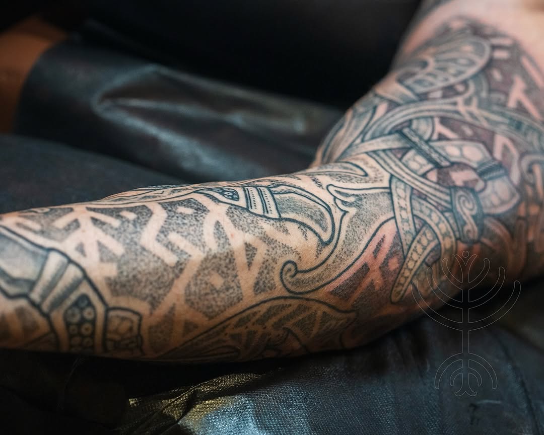Nordic knotwork forearm tattoo with bold blackwork shading