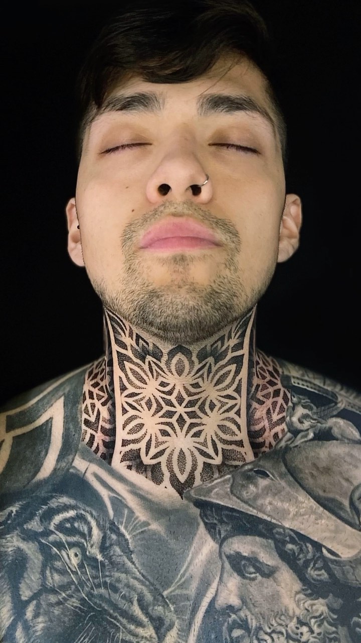 Intricate geometric neck mandala with bold blackwork.