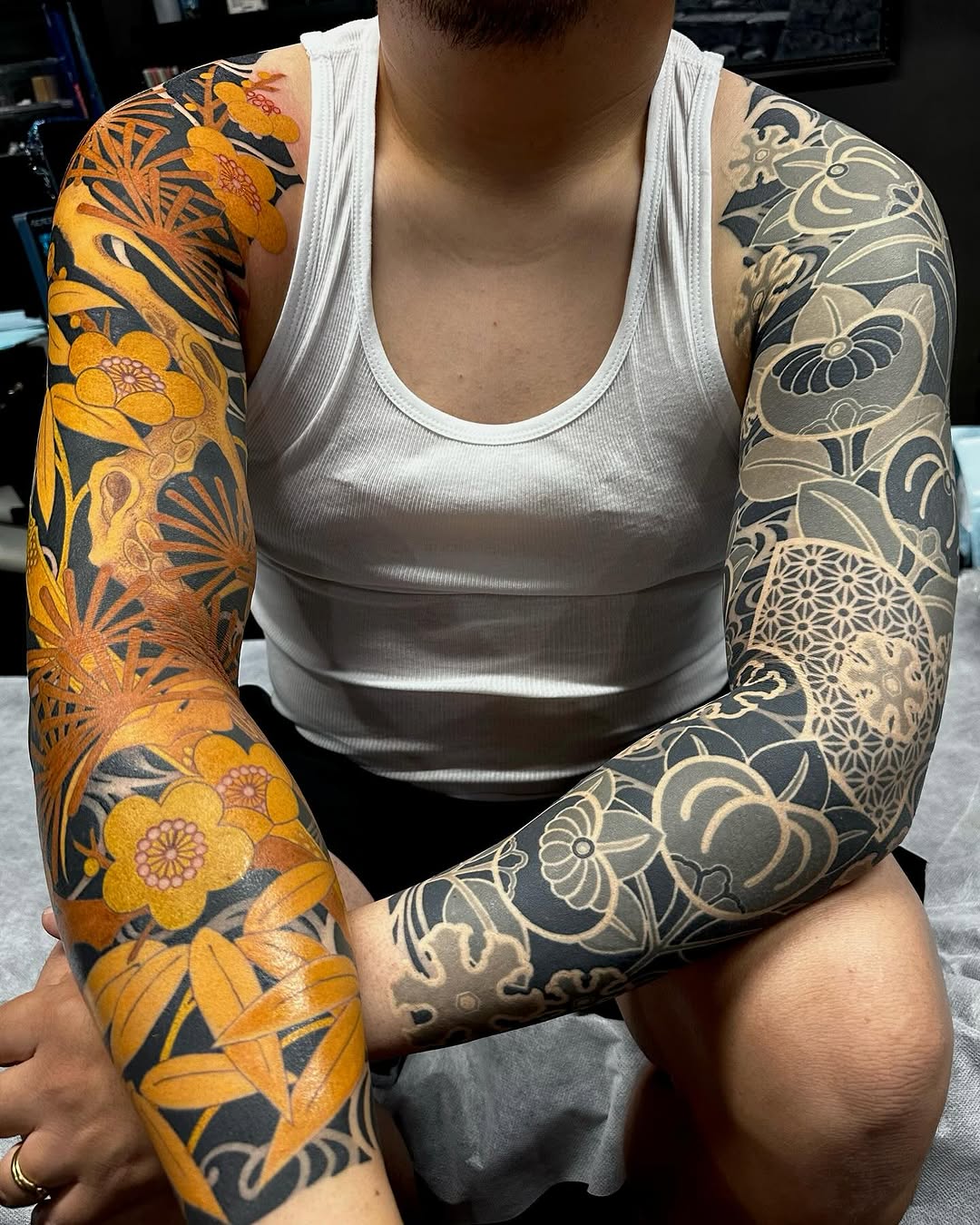 Vibrant orange plum blossoms contrasted with grayscale geometric florals