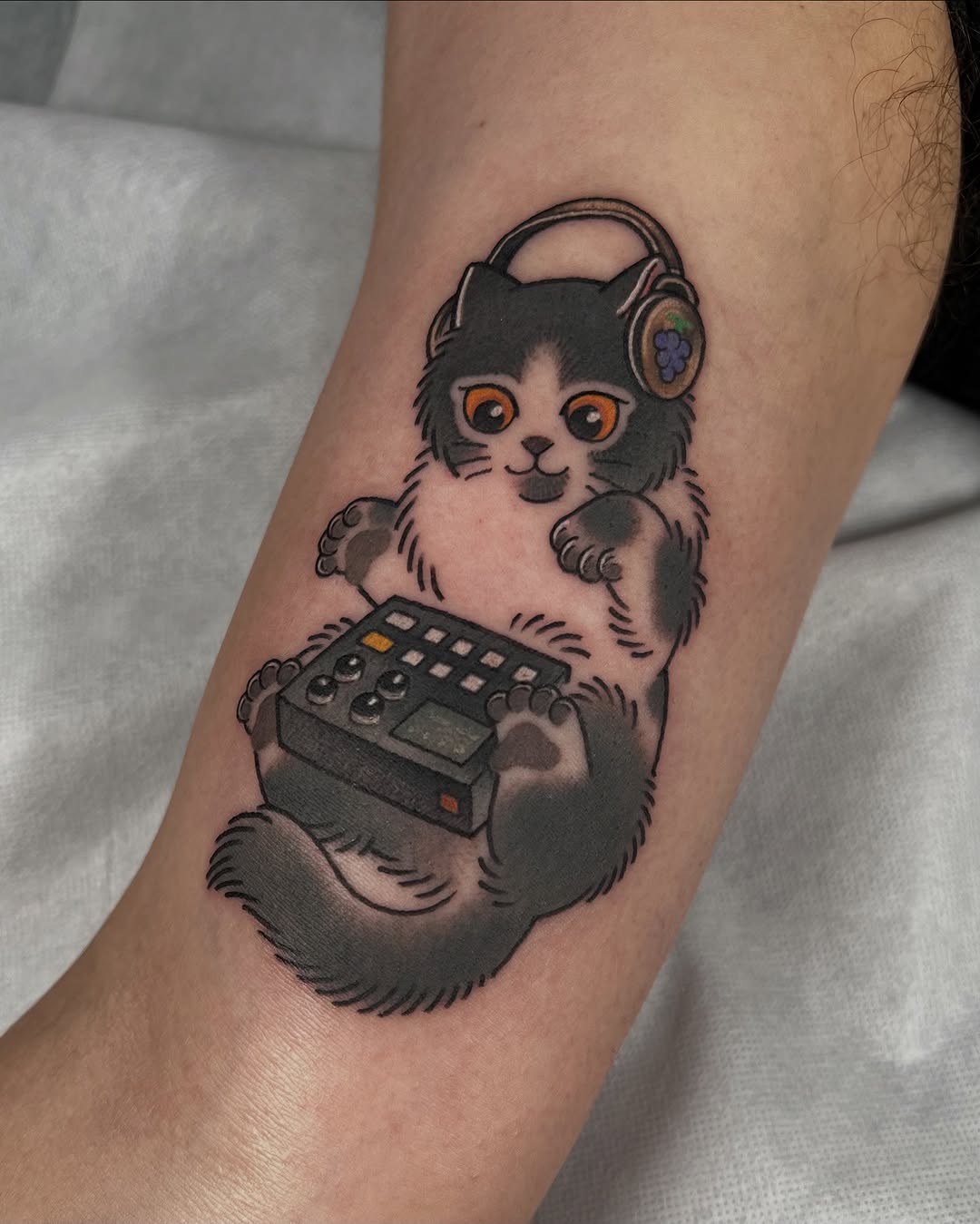 Playful cartoon cat wearing headphones holding a retro device