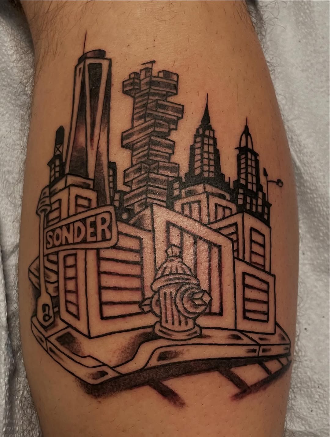 Bold black cityscape with towering blocks and hydrant.