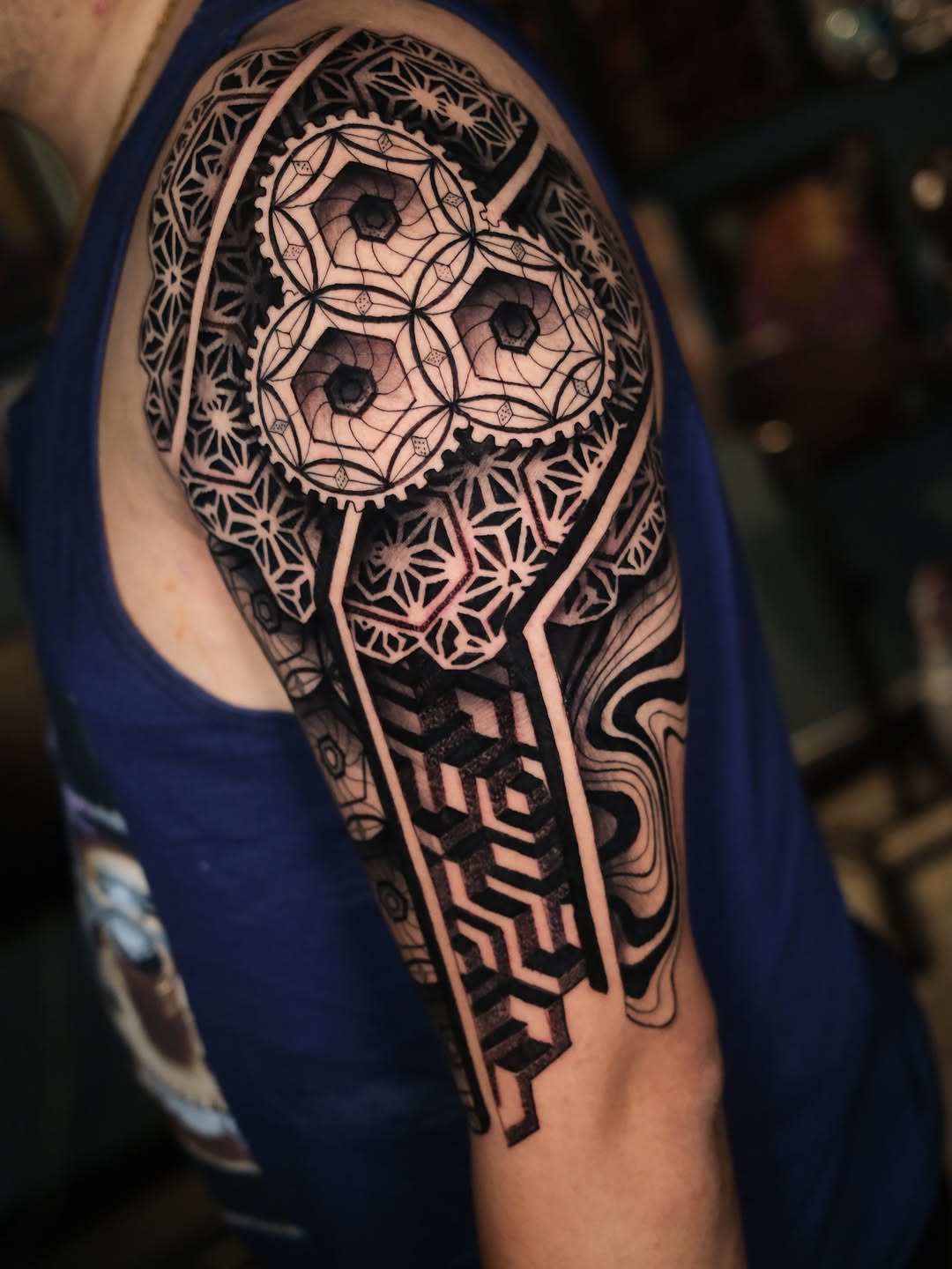 Intricate geometric blackwork with mandala-inspired hexagonal motifs.