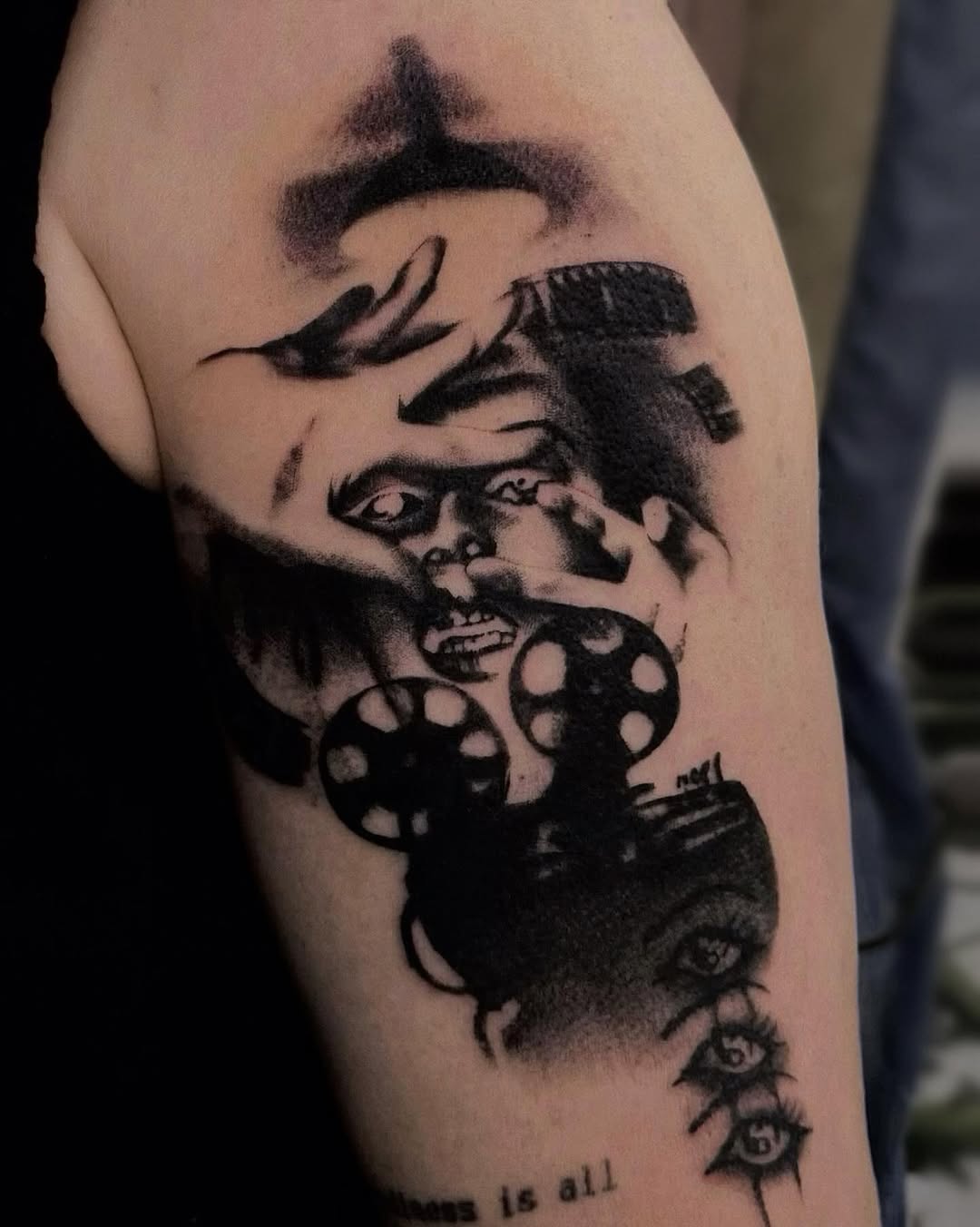 Bold blackwork surreal portrait with film-reel motifs on arm