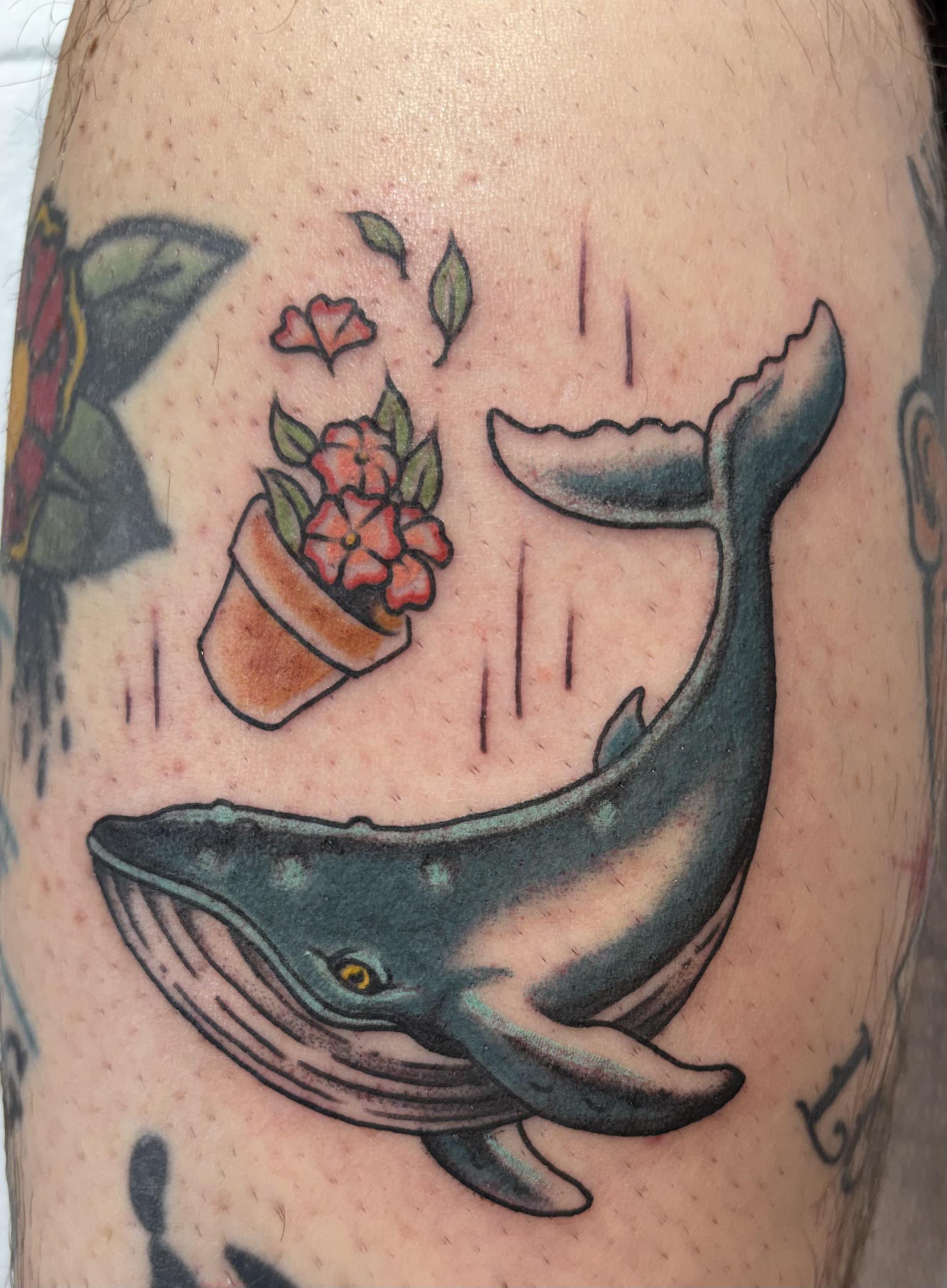 Bold traditional whale with floating floral bouquet