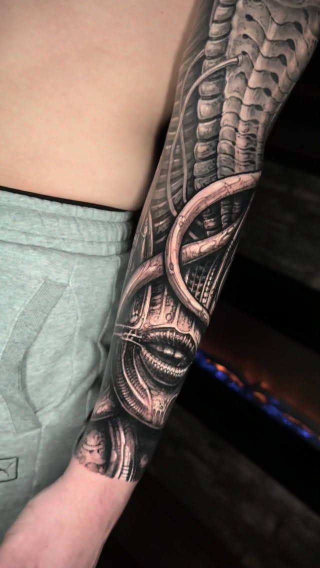 Giger-inspired biomechanical forearm piece with eerie mouth