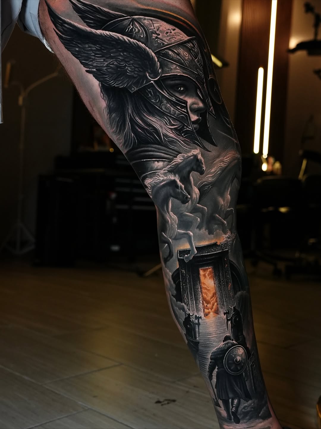 Monochrome Norse mythic scene with Valkyrie helmet and gateway.