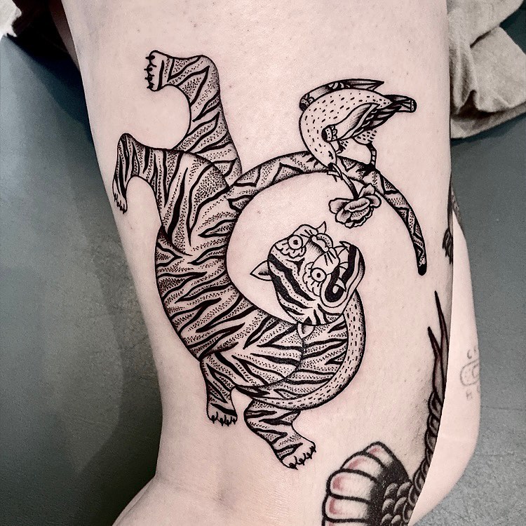 Bold blackwork tiger with dotted shading and parrot