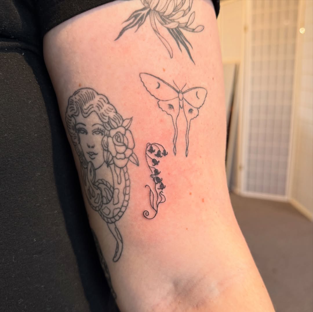 Delicate blackline portrait with rose, moth, and florals