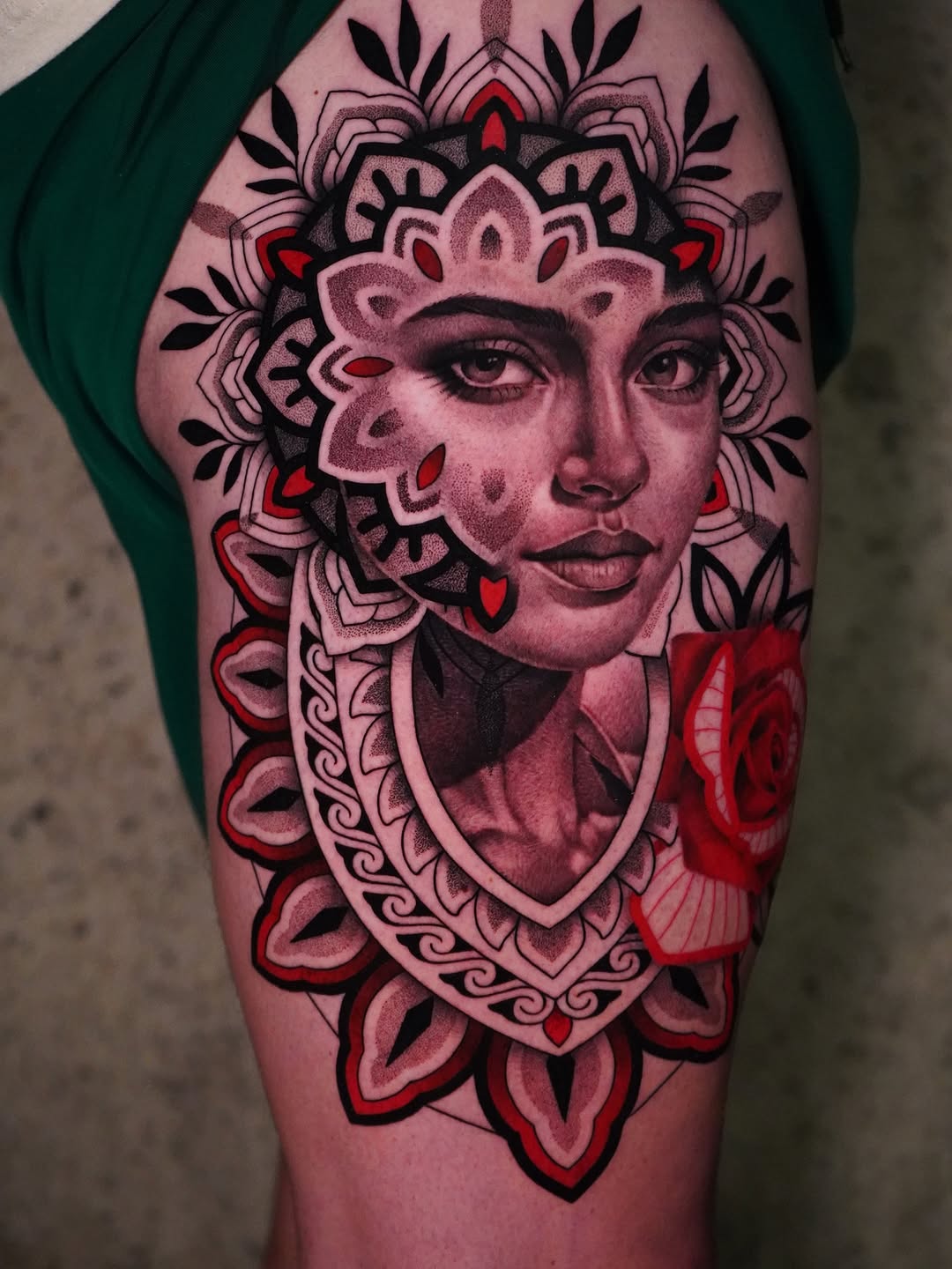 Intricate blackwork portrait with mandala halo and red rose accents.