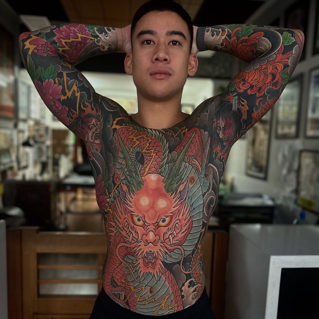 Vibrant Japanese dragon sleeve spanning chest and arms