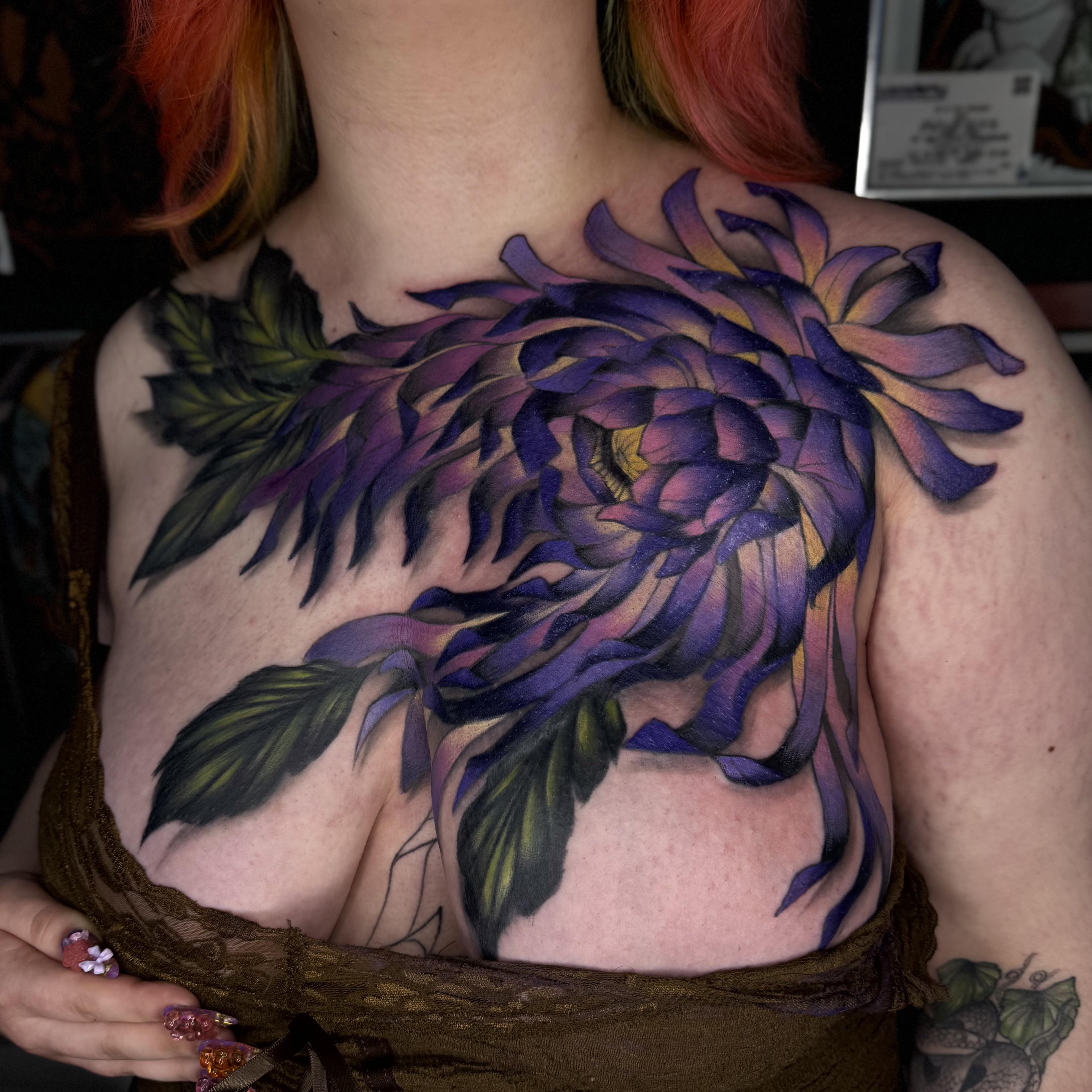 Vibrant purple chrysanthemum blooms across chest