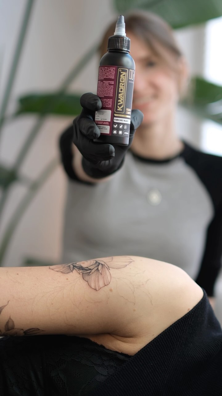 Delicate botanical flower linework on forearm in fineline