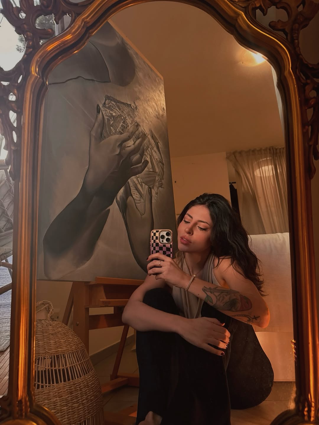 Bold black botanical forearm tattoo with leaves and vines