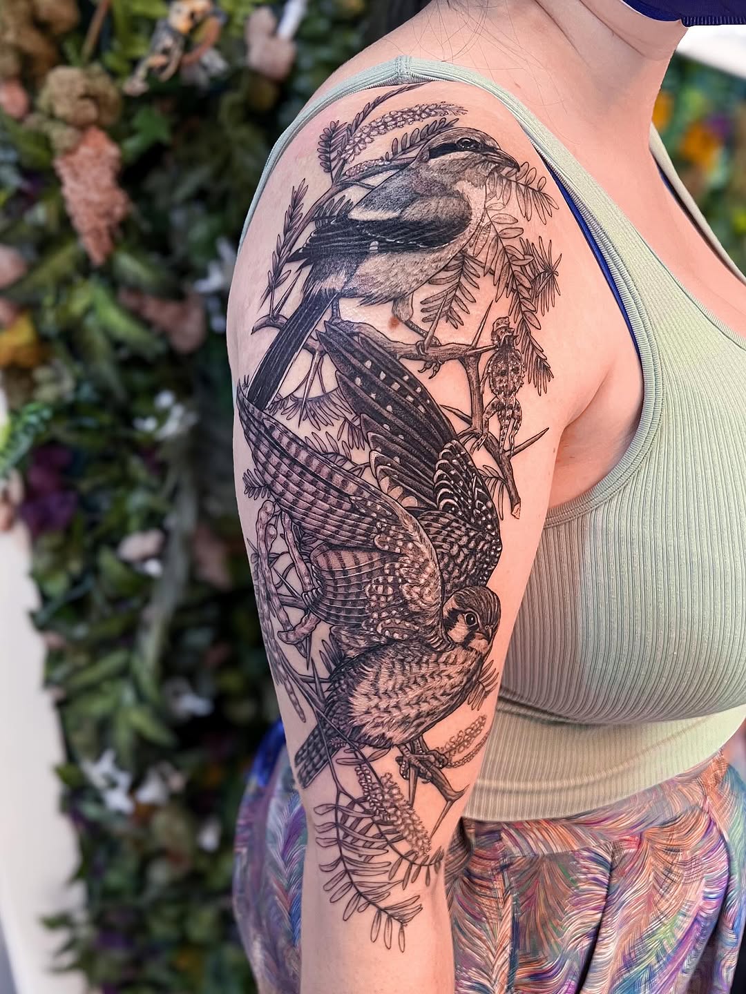 Intricate black-and-gray wildlife sleeve with kestrel and shrike