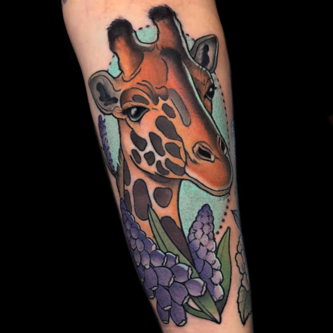 Bold neo-traditional giraffe portrait with purple lupine blooms.