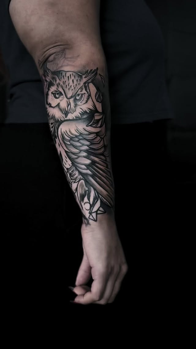 Owl tattoo on forearm