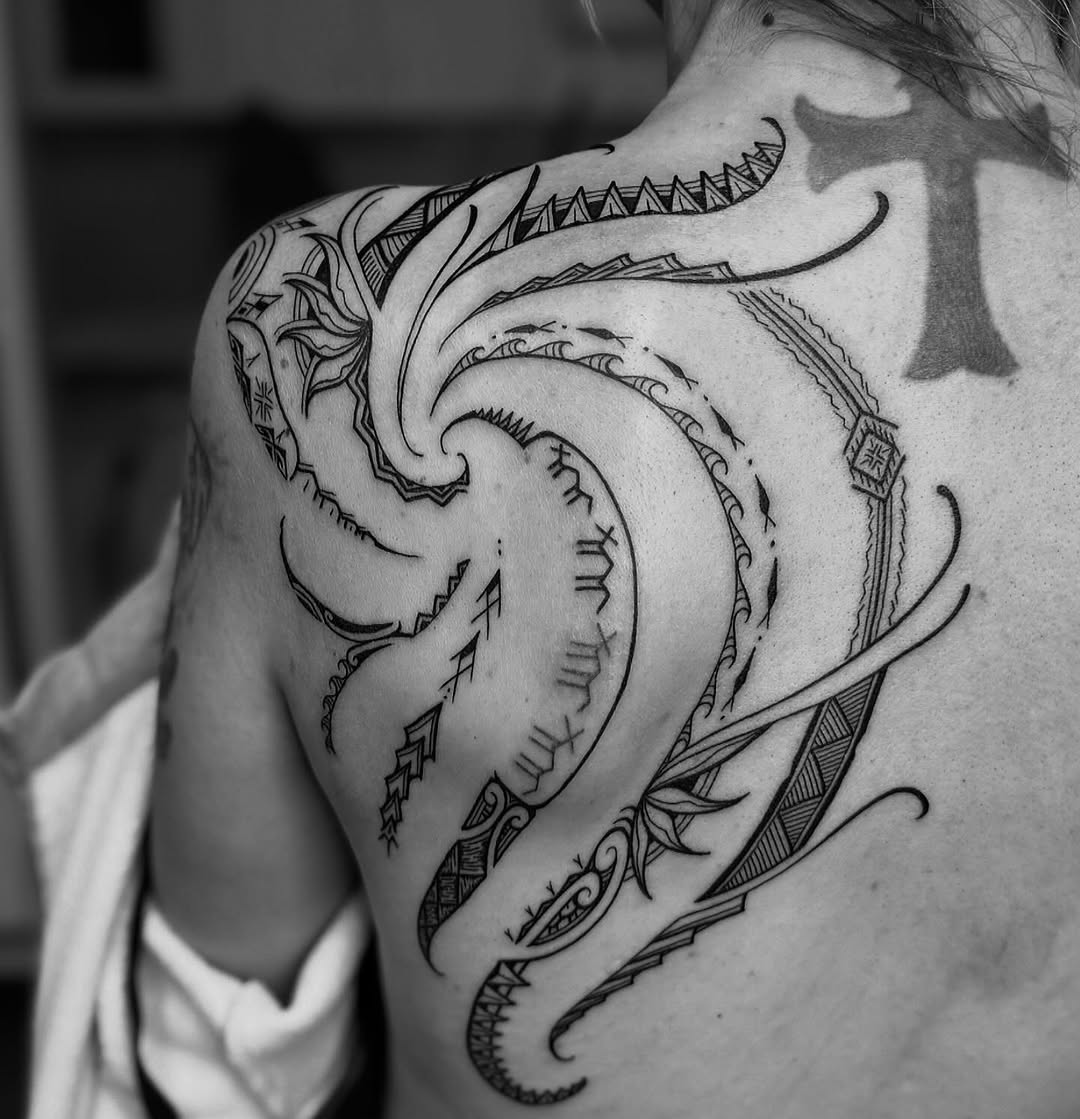Bold Polynesian tribal back piece with flowing geometric motifs