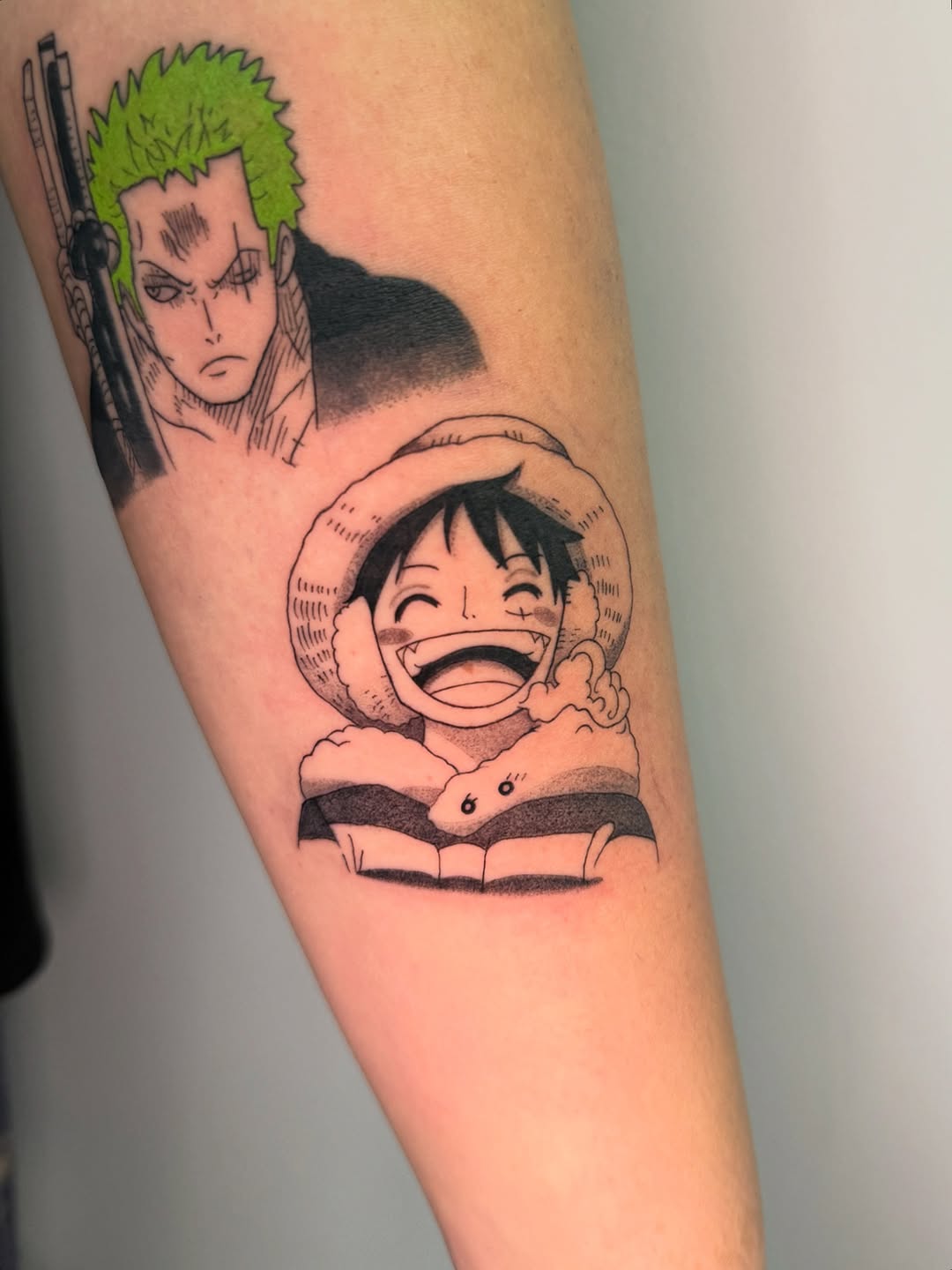 Bold blackline duo of Luffy and Zoro on forearm