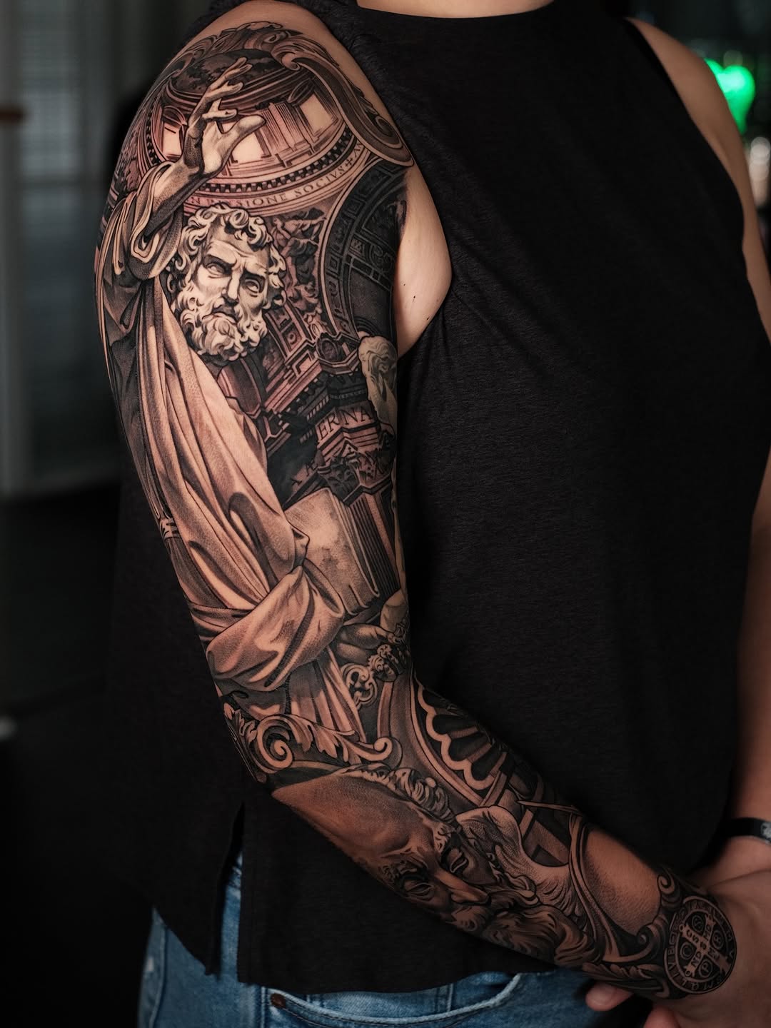 Intricate black-and-gray realism sleeve with classical statue motifs