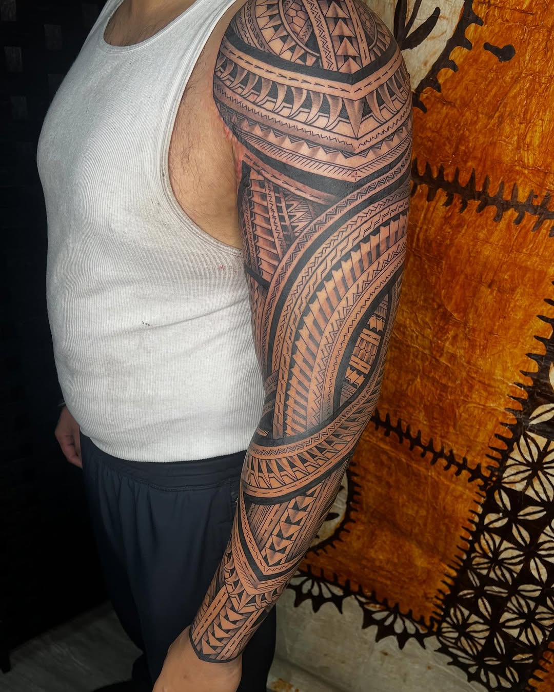 Bold Polynesian full-sleeve with intricate black tribal motifs