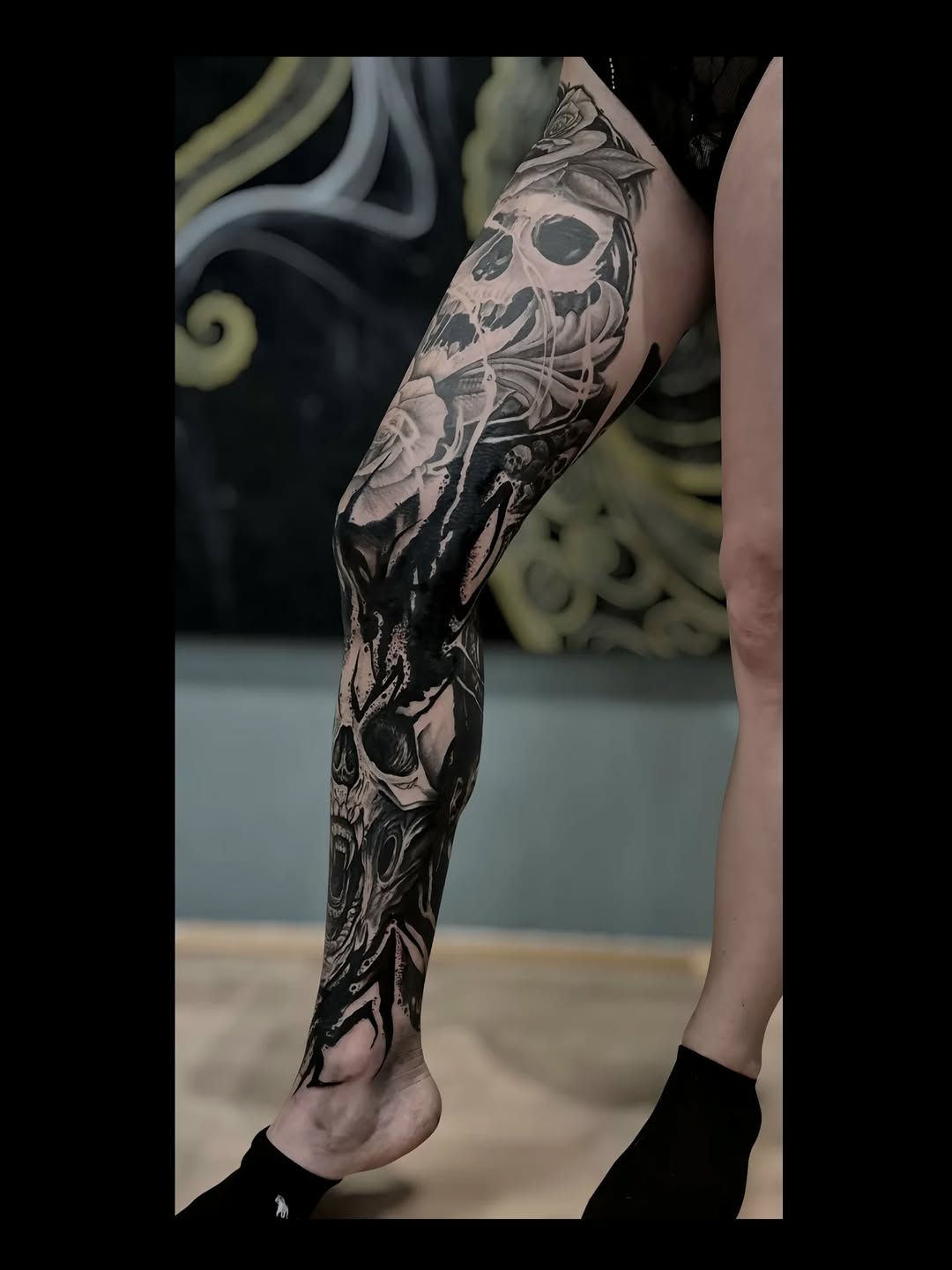 Gothic blackwork leg sleeve with skulls and floral textures