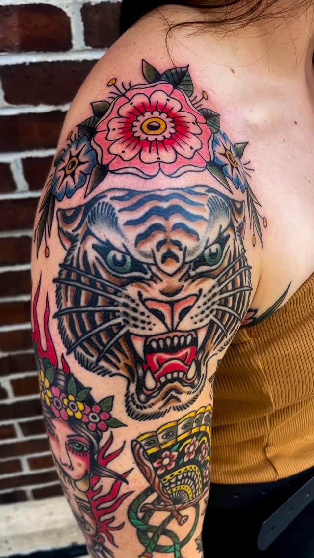 Bold neo-traditional tiger head with vivid floral halo