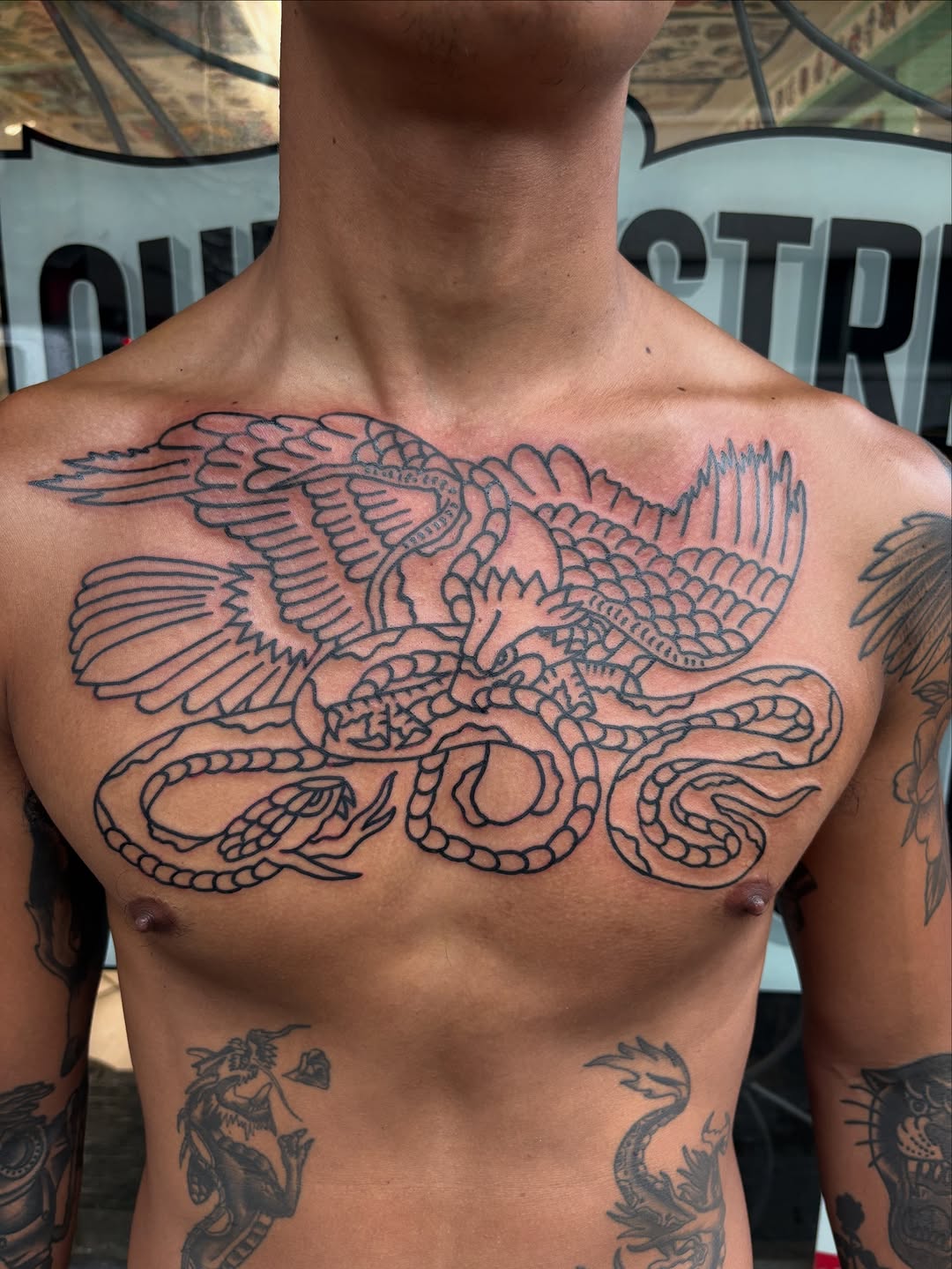 Bold winged serpent dragon across the chest, blackline.