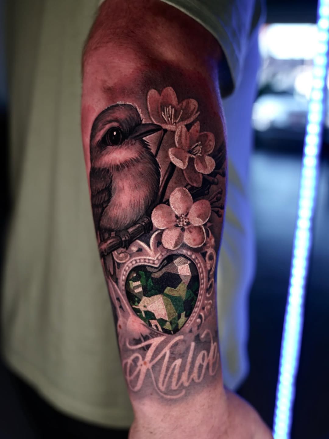 Hummingbird with blossoms and a mosaic emerald heart