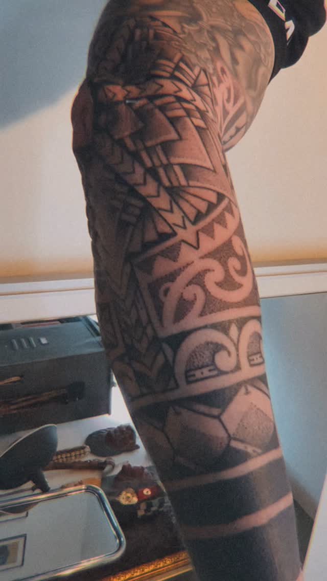 Bold blackwork geometric sleeve with Polynesian-inspired motifs