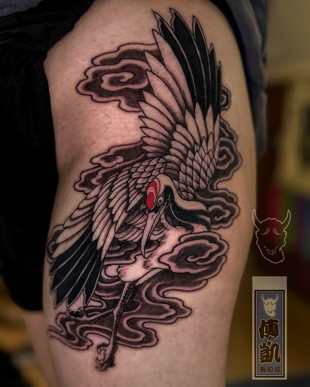 Neo-traditional crane in flight amid swirling clouds.