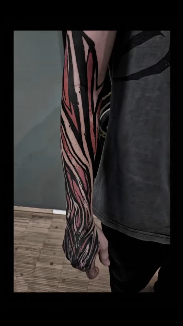 Bold black-and-pink abstract sleeve with sharp swirls