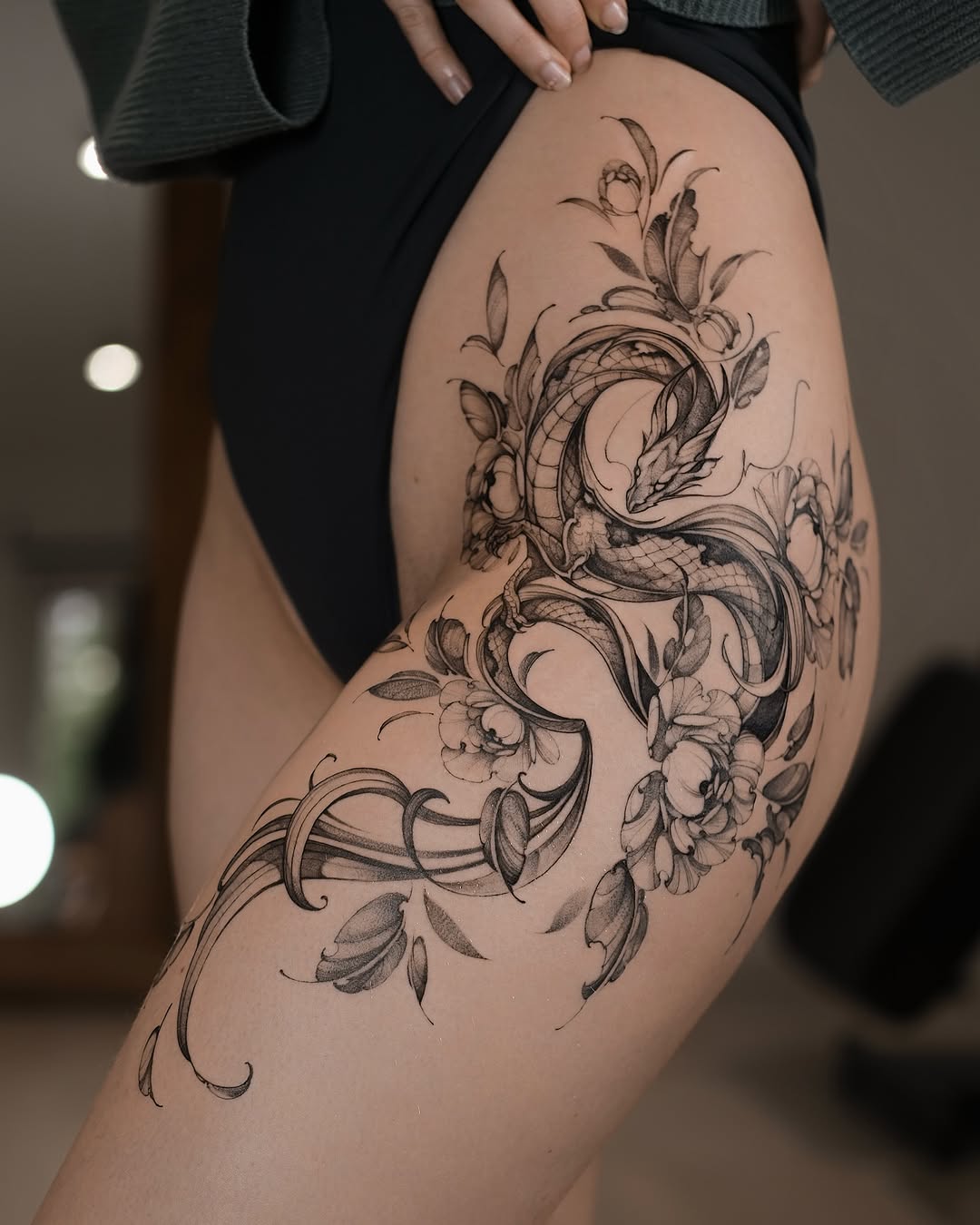 Elegant black-and-gray dragon entwined with flowing blossoms