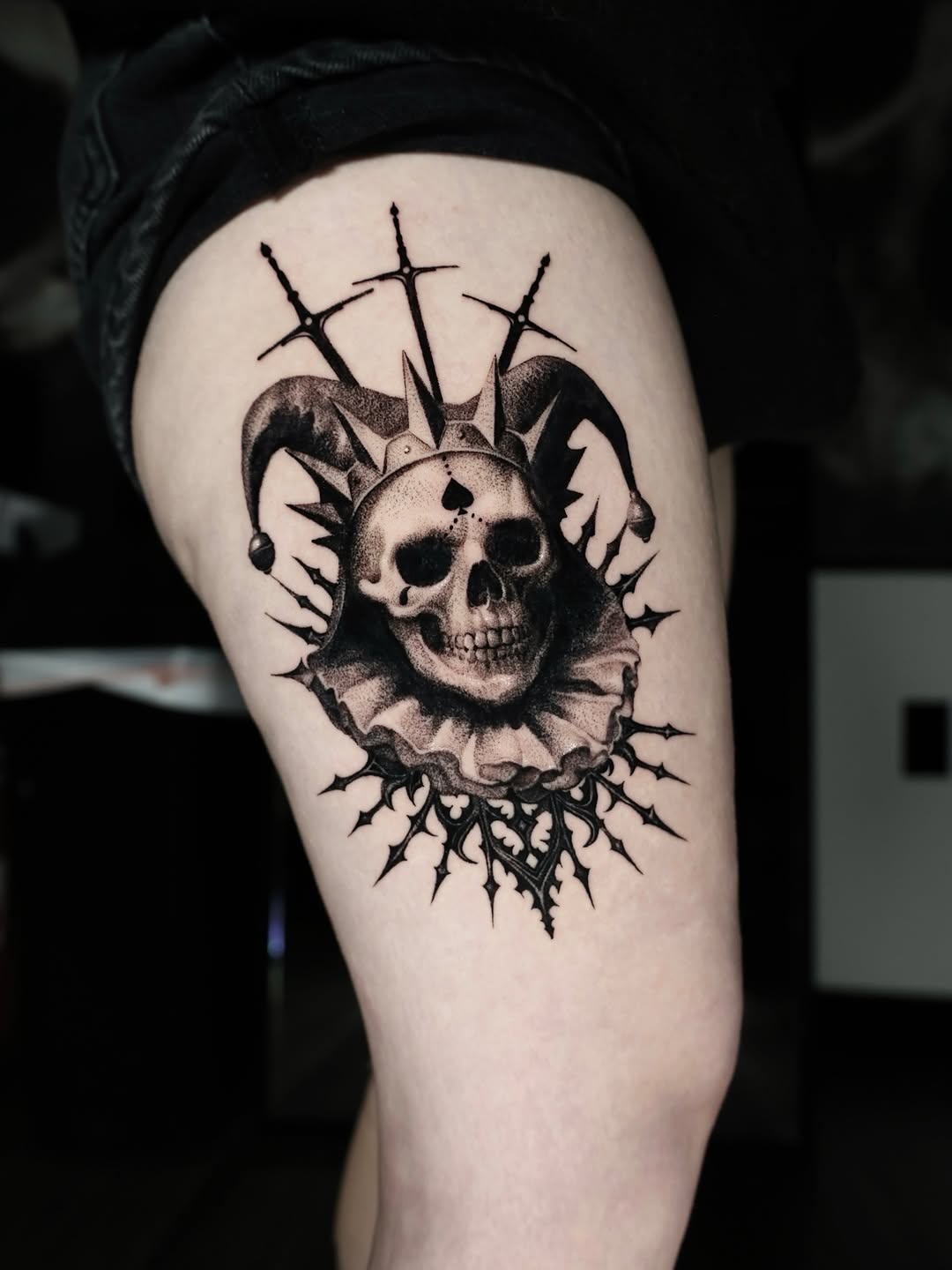 Dark skull with crown, surrounded by spiky blackwork