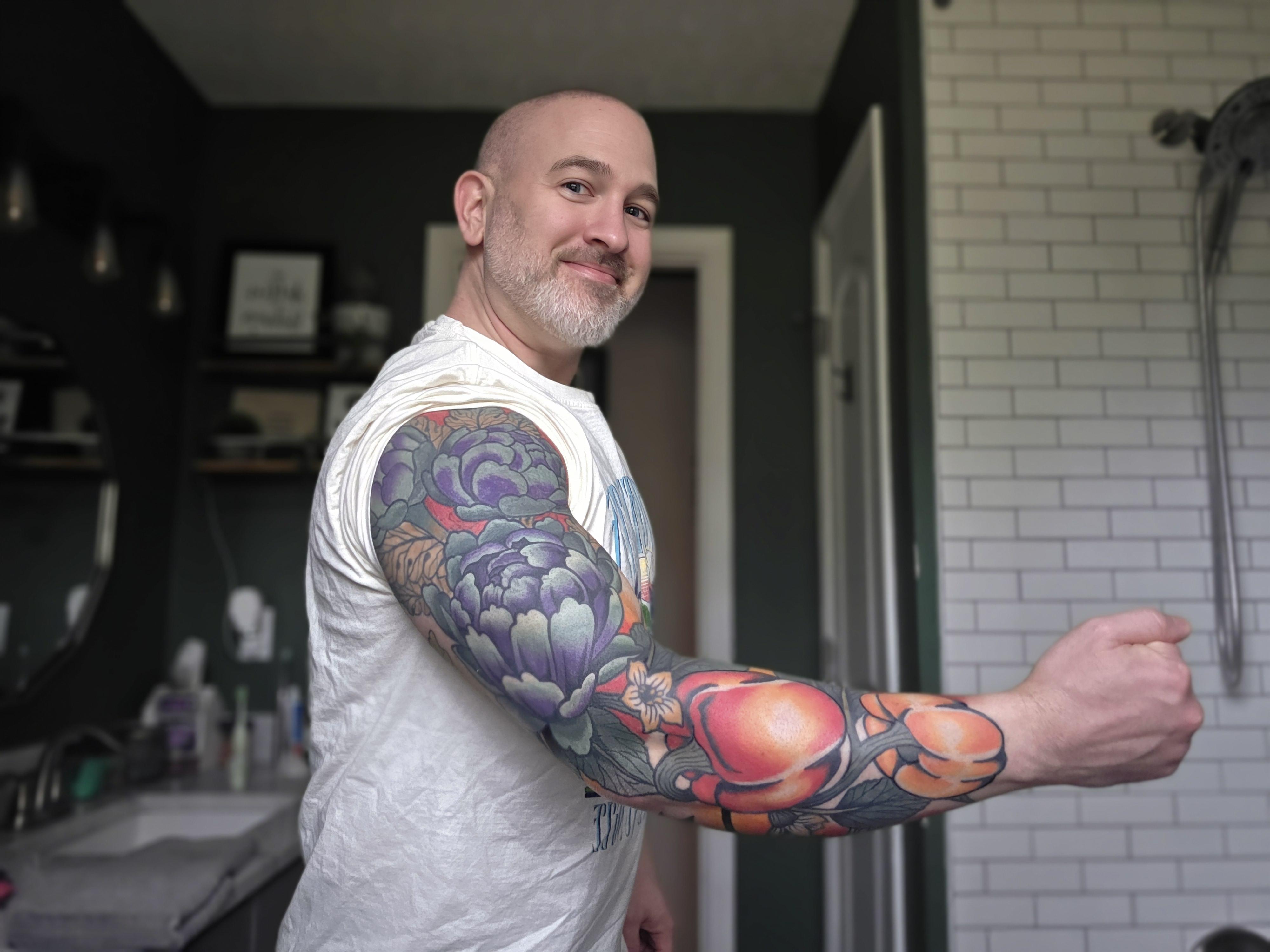 Vibrant botanical sleeve with purple peony florals and orange fruit accents