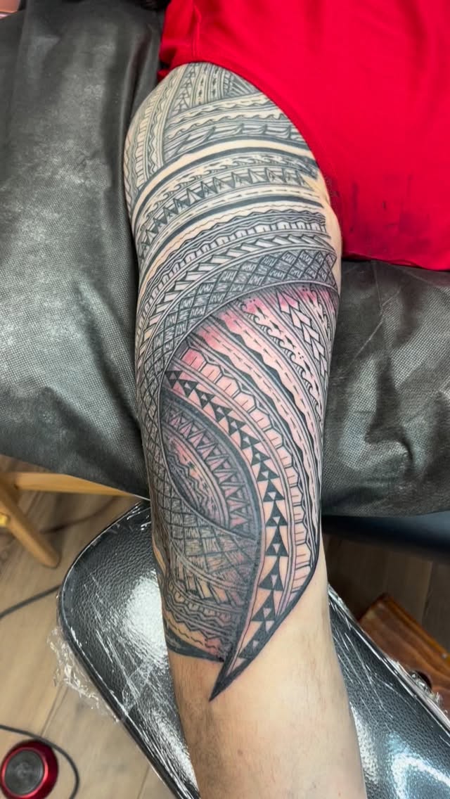 Intricate Polynesian tribal sleeve with bold black bands.