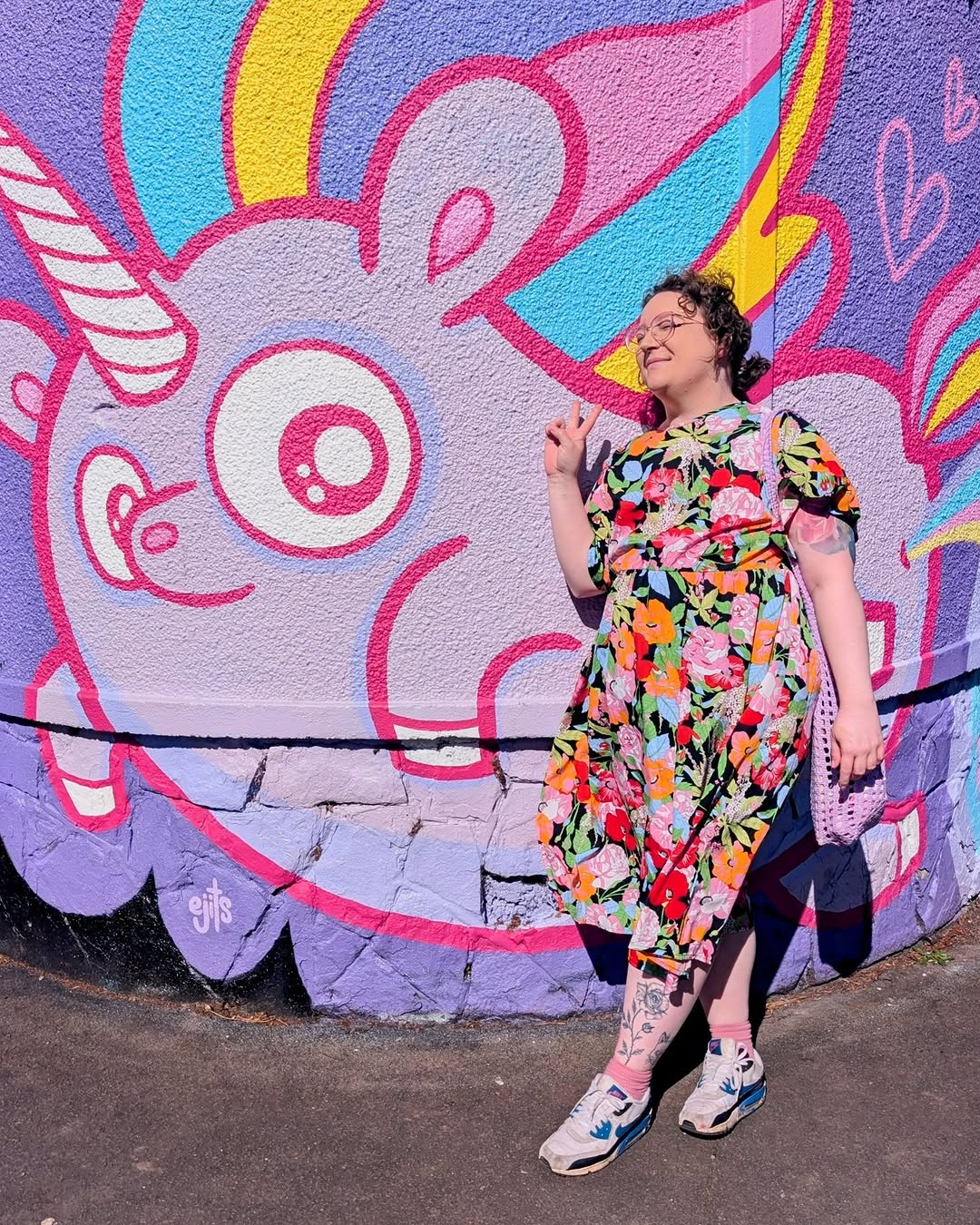 Floral vine leg tattoo in bold blackwork on calf