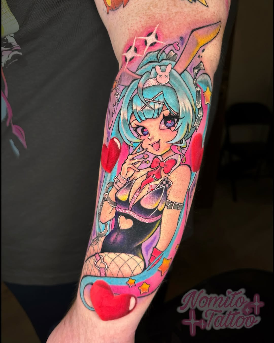 Vivid anime-inspired Hatsune Miku bunny-girl tattoo on forearm