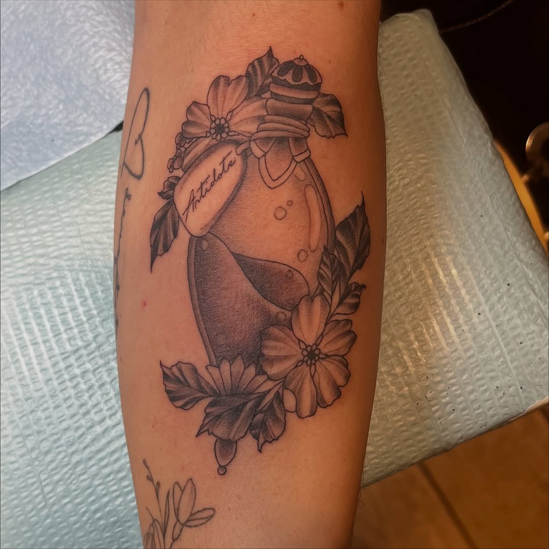 Delicate apothecary bottle entwined with blooming flowers