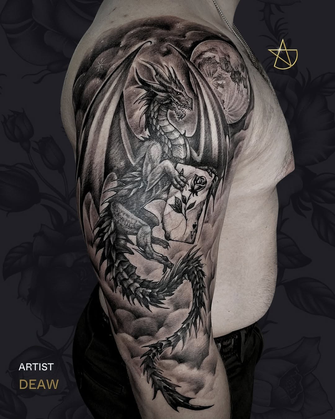 Monstrous dragon in grayscale coils across the arm.