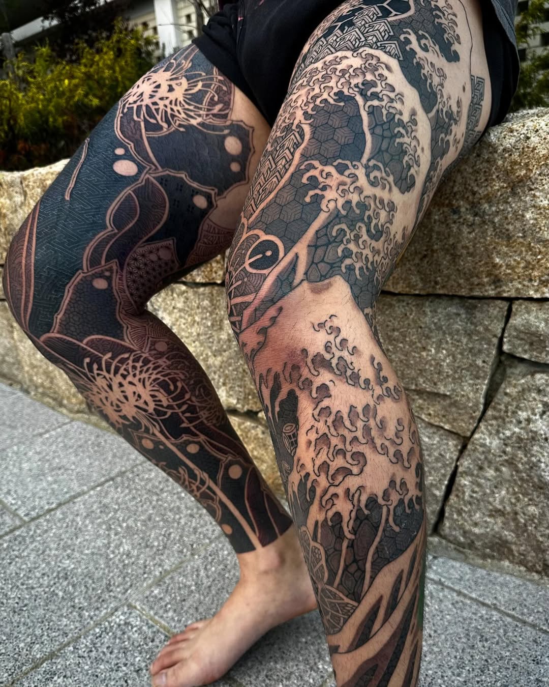 Intricate blackwork leg sleeve with waves and geometrics