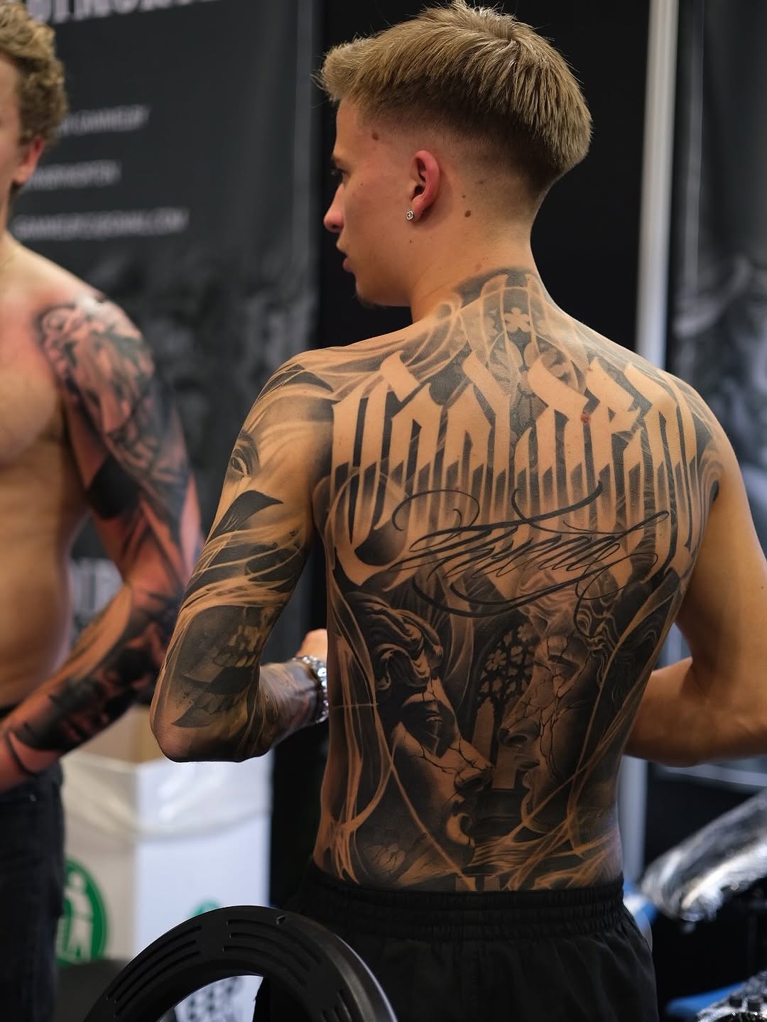 Massive blackwork back piece with bold gothic script