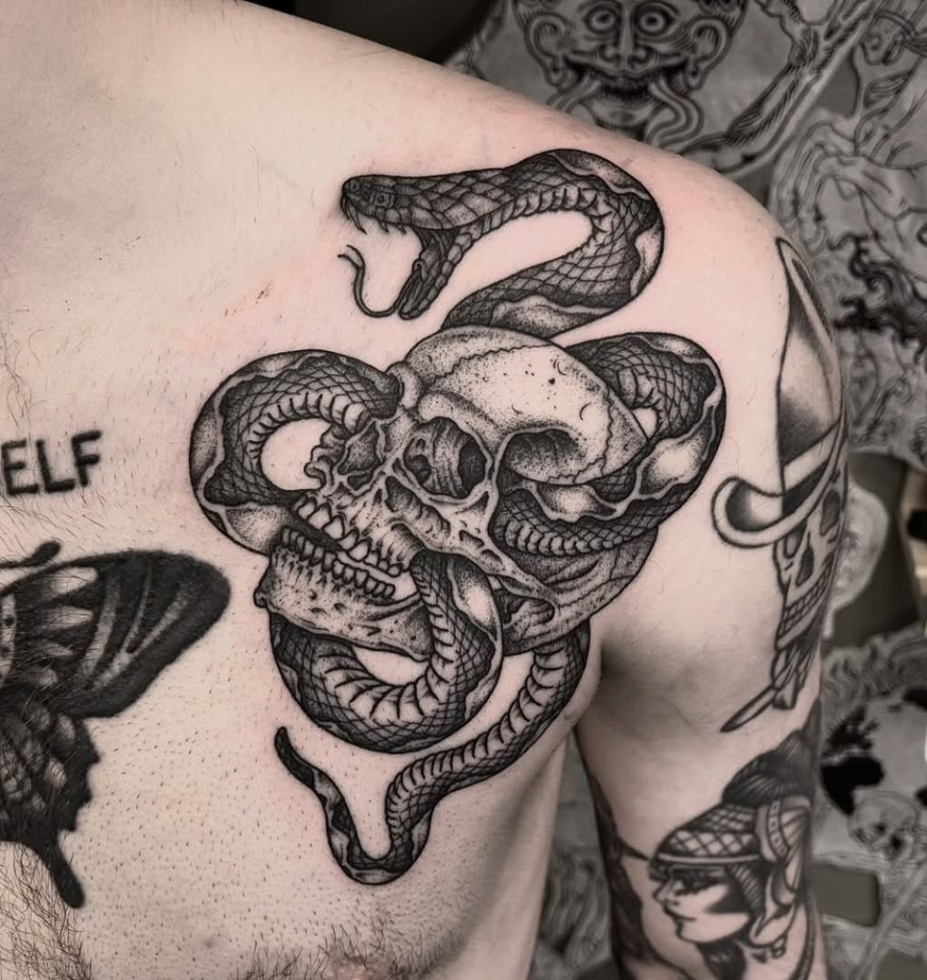 Bold blackwork skull entwined with a coiled rattlesnake