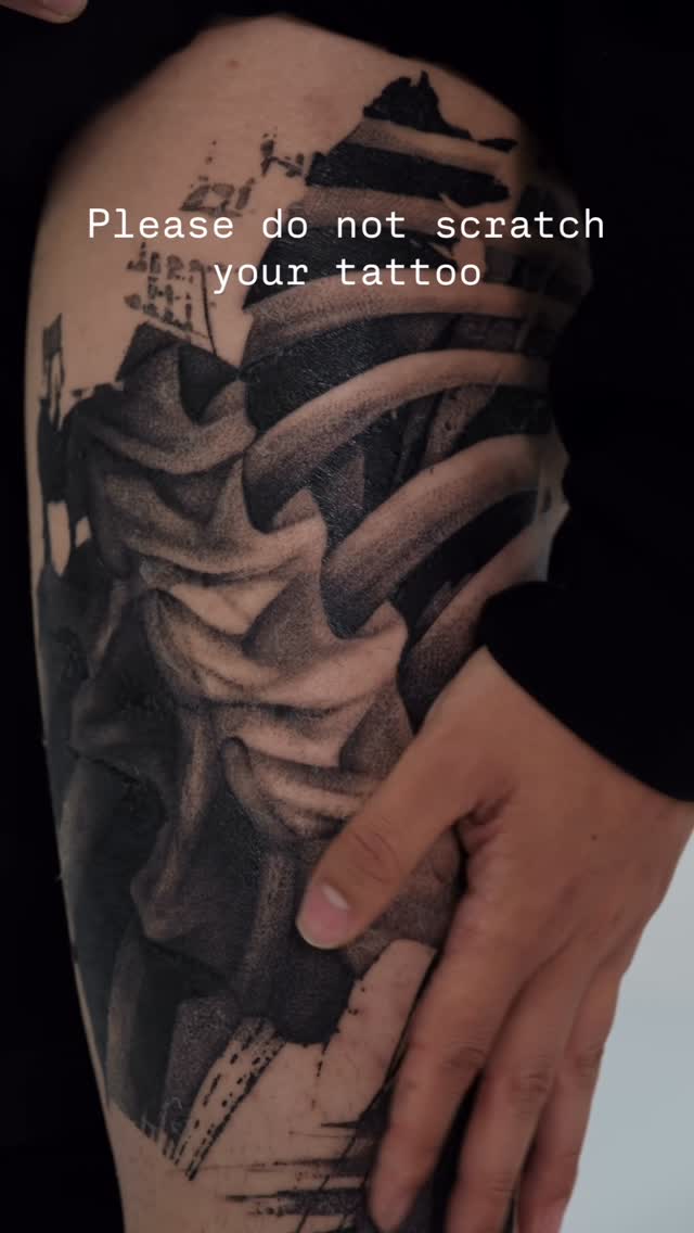 Monochrome brush-stroke blackwork abstract forearm tattoo