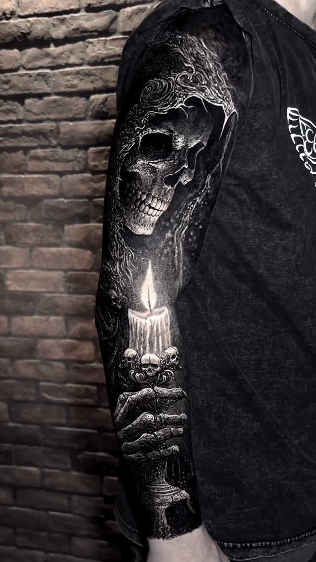Dark black-and-gray skull candle sleeve with ornate details