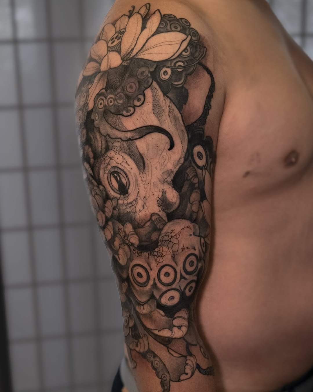 Intricate blackwork octopus sleeve with curling tentacles and suction cups