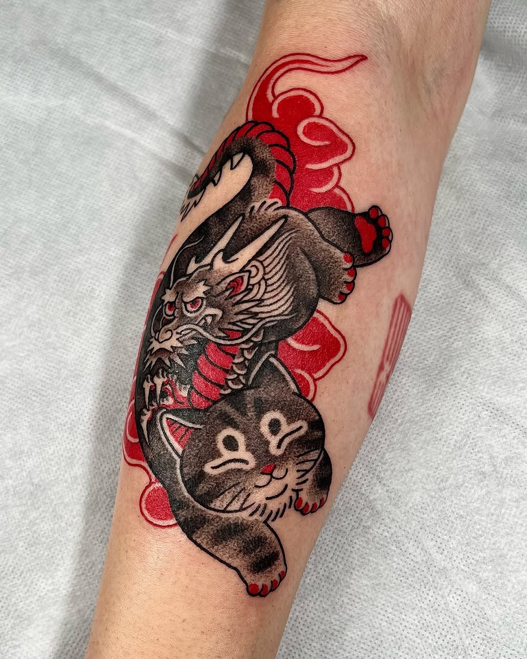 Bold black dragon with red cloud backdrop.