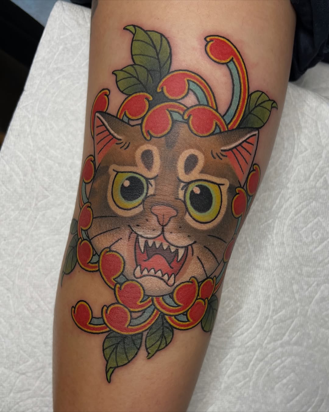 Whimsical cartoon cat with vibrant red berries and leaves