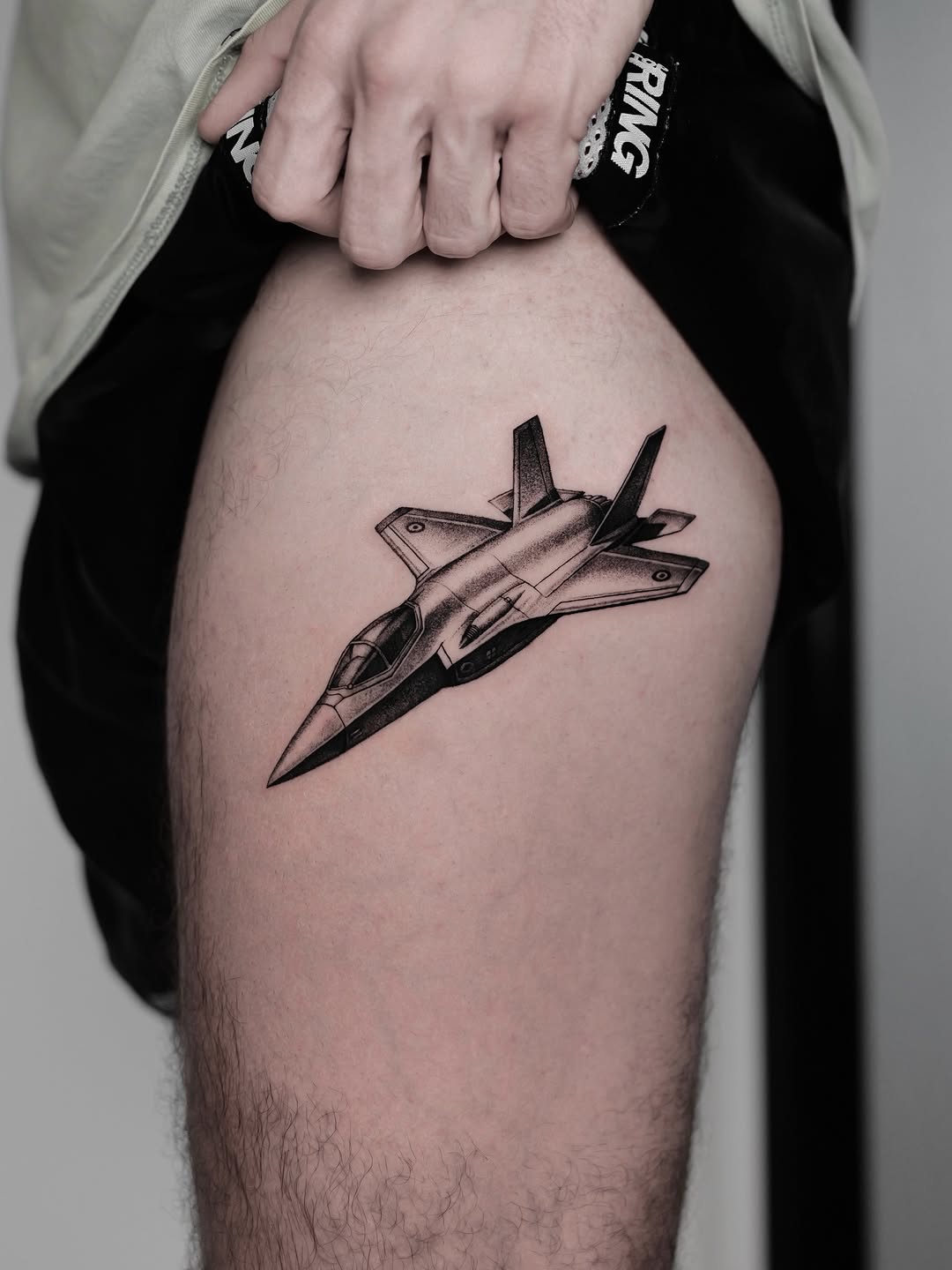 Sleek grayscale fighter jet with bold shading